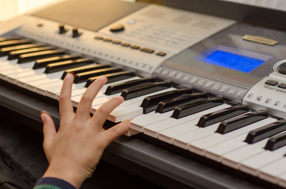 Kid playing keyboard